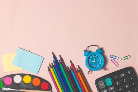 Education or back to school concept. Top view of colorful school supplies with books, color pencils,...