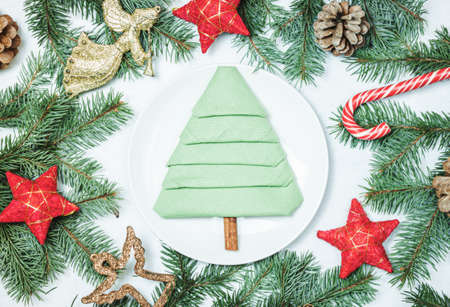 Christmas table setting with vintage dishware and red decorations on gray background. Top view. Flat lay designの写真素材