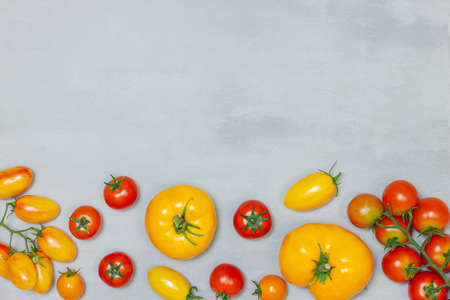 Red tomato and basil leaves isolated on white background. Top view. Composition from tomato and fresh herbの写真素材