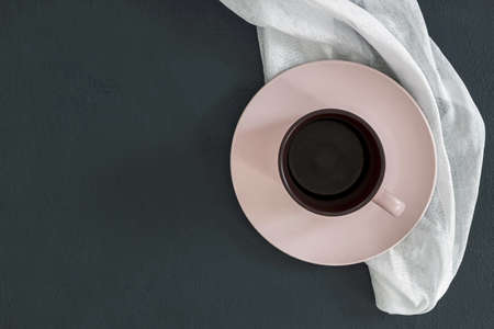 Empty pink plate on black table and napkin. Food background for menu, recipe. Table setting. Flatlay, top view. Mockup for restaurant dishの写真素材