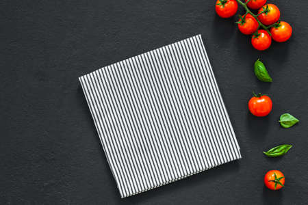 Empty plate. ? lassic italian food background tomato, basil on dark table. Top view.