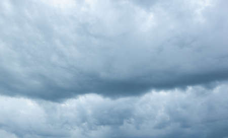 Cloudy sky. Stormy dark sky. Dark storm clouds in the evening spring skyの写真素材