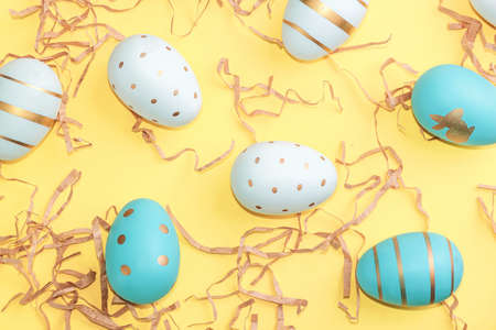 Easter background with Easter eggs on yellow background. Spring holiday. Top view, Flatlay