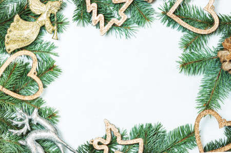 Christmas border made of fir branches, festive gold decoration. Flat lay. top view with copy spaceの写真素材