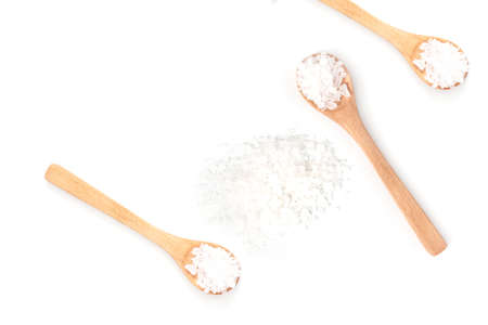 Sea salt on wooden spoon isolated on white background. Top view