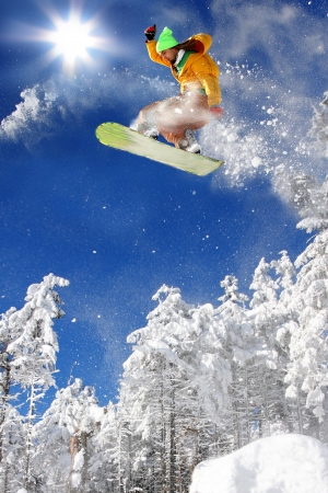 Snowboarder jumping against blue sky Snowboarder jumping against blue sky
