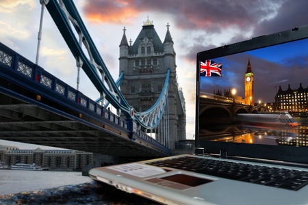 Tower Bridge with Big Ben on screen of notebook, London, UK 