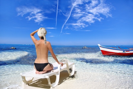 Young beautiful women on the sunny tropical beach in bikini の写真素材