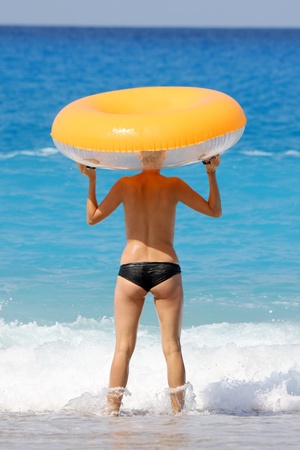 Sexy woman with swimming belt on the beach の写真素材