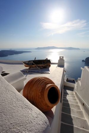 Santorini with old Vase and boat on white roof in Fira, Greeceの写真素材