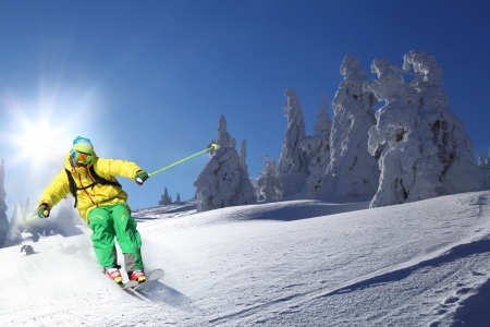 Skier skiing downhill in high mountainsの写真素材