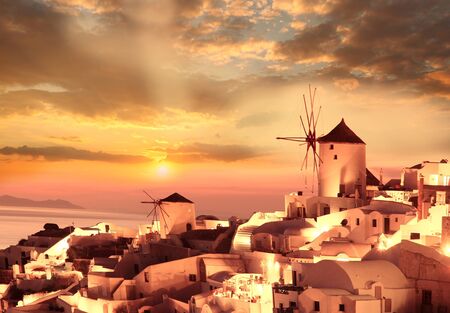 Windmill against colorful sunset, Santorini, Greeceの写真素材