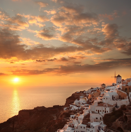 Windmills against colorful sunset in Santorini, Greeceの写真素材