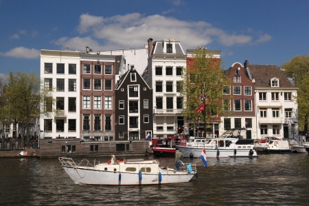 Amsterdam city with boats on canal in Hollandの写真素材