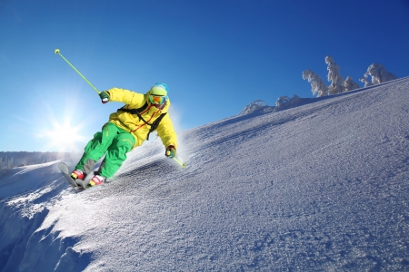 Skier skiing downhill in high mountainsの写真素材