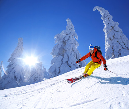 Skier skiing downhill in high mountainsの写真素材