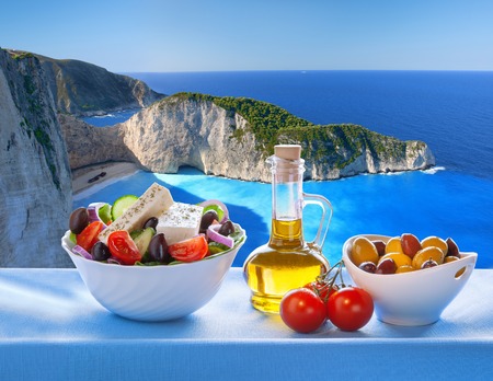 Famous Navagio beach with Greek salad in Zakynthos Greeceの写真素材