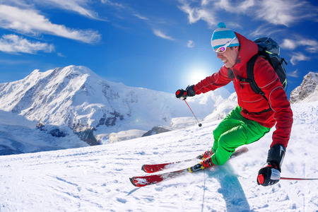 Skier skiing downhill in high mountains, Matterhorn area, Switzerlandの写真素材