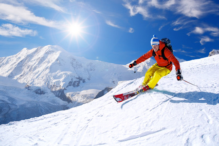 Skier skiing downhill in high mountains, Matterhorn area, Switzerlandの写真素材