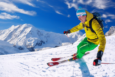 Skier skiing downhill in high mountains, Matterhorn area, Switzerlandの写真素材
