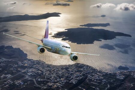 Airplane above the Santorini island in Greeceの写真素材