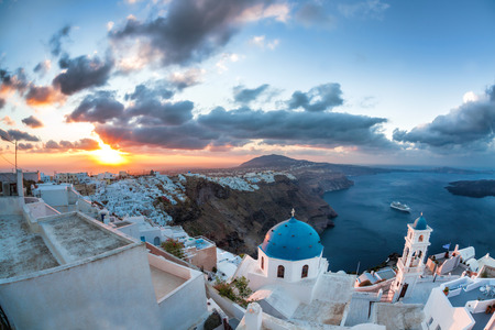 Sunrise against church on Santorini island in Greeceの写真素材