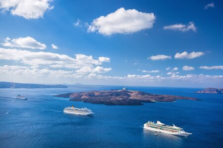 Ships against Volcano on Santorini island in Greeceの写真素材