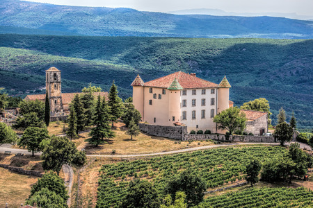 View Of Aiguines Village And Renaissance-style Chateau with mountains in Provence, Franceのeditorial素材