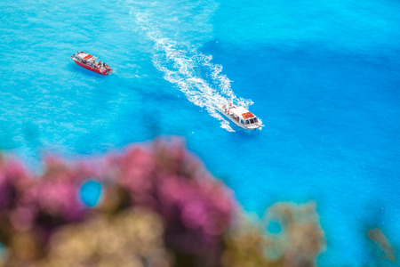 boats on the azure sea against flowersの写真素材
