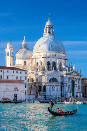 Grand Canal with gondola against Basilica Santa Maria della Salute in Venice, Italyの写真素材