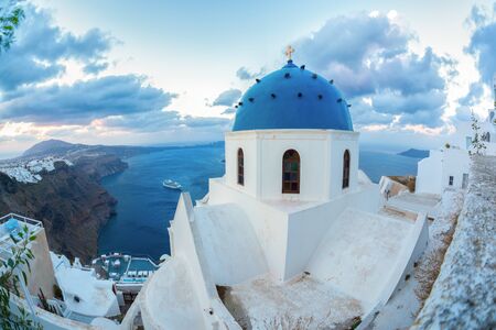 Santorini island with church against sunrise in Greeceの写真素材