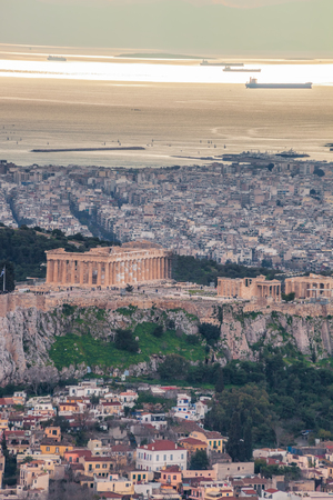 Parthenon temple on the Acropolis against sea in Athens, Greeceの写真素材