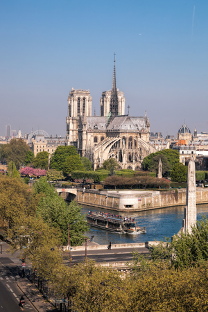Paris, Notre Dame cathedral with boat on Seine, Franceのeditorial素材