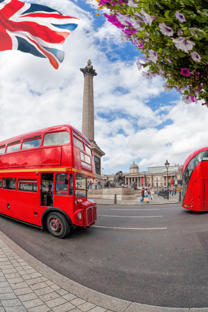 Trafalgal square with red buses in London, Englandの写真素材