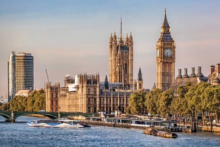 Big Ben and Houses of Parliament with boats on the river in London, England, UKの写真素材