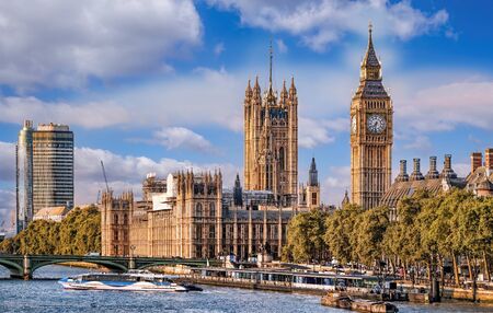 Big Ben and Houses of Parliament with boats on the river in London, England, UK