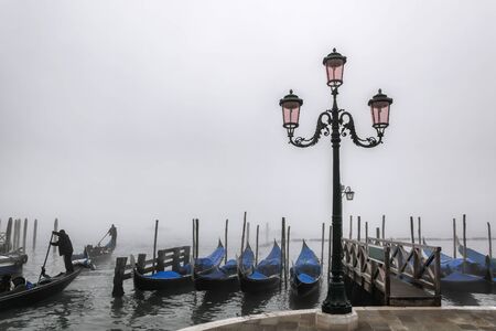 Venice with gondolas against foggy day in Italyの写真素材