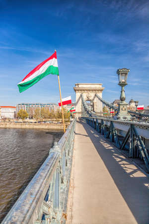 Badapest and famous chain bridge with Hungarian flags over Danube river in Hungaryのeditorial素材