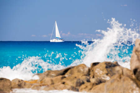Azure coast of Calabria with sailboats on open sea in Vibo Valentia, Calabria, Southern Italyの写真素材