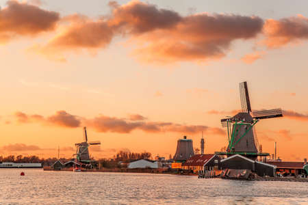 Traditional Dutch windmills against colorful sunset in Zaanse Schans, Amsterdam area, Hollandの写真素材