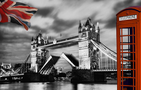 Tower Bridge lift time against red phone booth in London, England, UKの写真素材