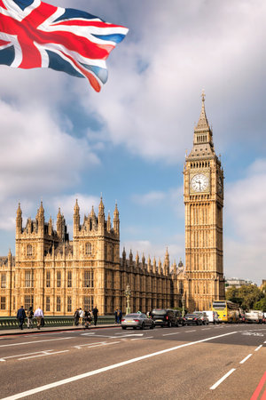 Big Ben with bridge against flag of England in London, England, UKの写真素材