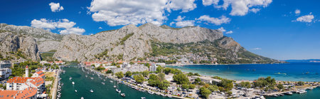 Amazing panorama of Omis wiith boats on Cetina river and beaches along the coast in Croatia