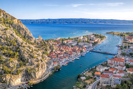 Amazing panorama of Omis wiith boats on Cetina river and old town along the coast in Croatiaの写真素材