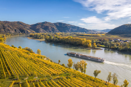 Autumn panorama of Wachau valley (Unesco world heritage site) with ships on Danube river near the Weissenkirchen village in Lower Austria, Austriaの写真素材
