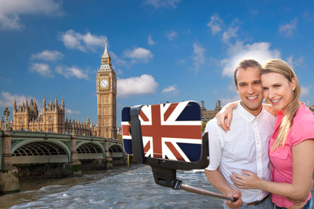 Couple in love taking a selfie portrait in front of Big Ben on their way around Westminster in London, Englandの写真素材