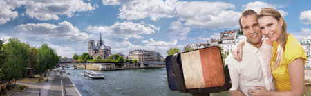 Happy couple of tourists taking selfie photo with cellphone covered a French flag in front of Notre Dame in Paris, Franceの写真素材