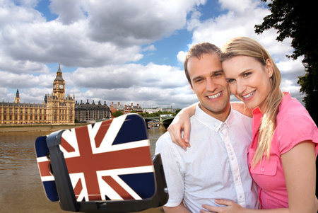 Couple in love taking a selfie portrait in front of Big Ben on their way around Westminster in London, Englandの写真素材