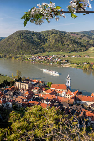 DÃ¼rnstein village with ship on Danube river during spring time in Wachau, Austriaの写真素材