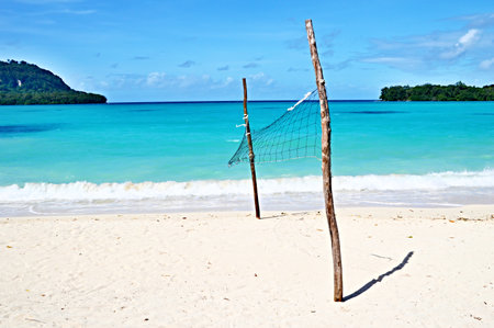 volleyball net on the sand beach with turquoise seaの写真素材